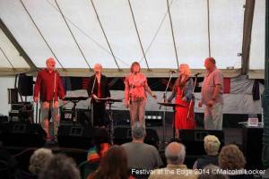 Raps battle the sound of the pouring rain on stage in the Silver Marquee, Festival At The Edge.